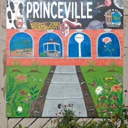 Princeville mural with Princeville across the top, picture windows with peonies, pumkins, the gazebo and water tower, and a sidewalk leading through the garden