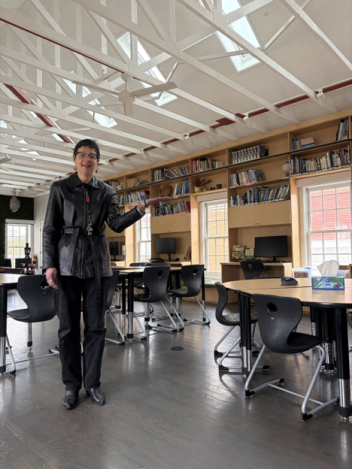 Librarian gesturing to the new collection items 