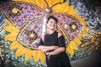 Catalina Maria Johnson in front of butterfly artwork