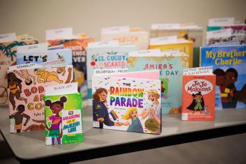 Image shows the covers of diverse books facing forward on top of a table