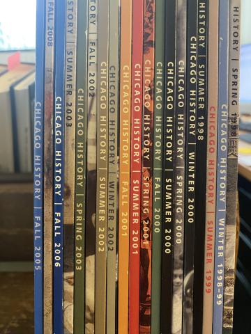Issues of Chicago History journal lined up on a book cart.